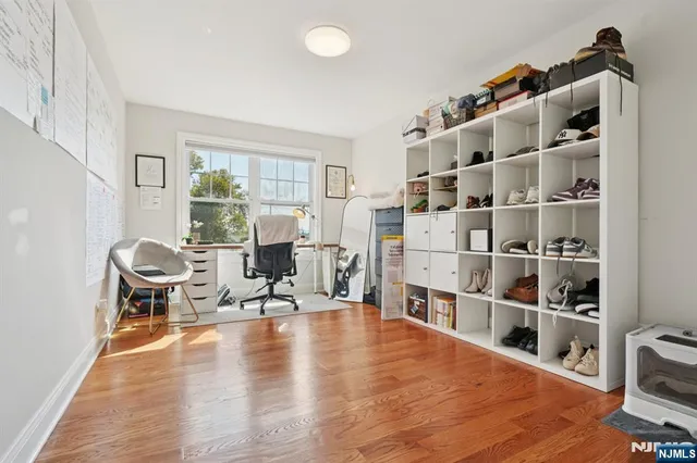 a living room with furniture cabinets and a book shelf