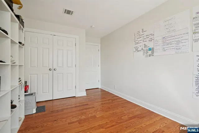 a view of hallway with wooden floor