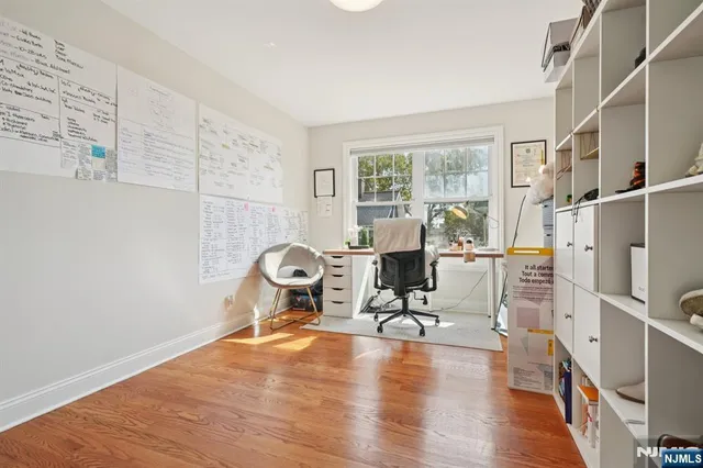 a view of a workspace with furniture and a window