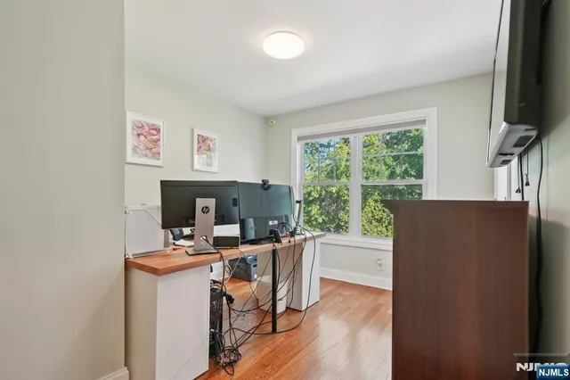 a view of a workspace with furniture and a window