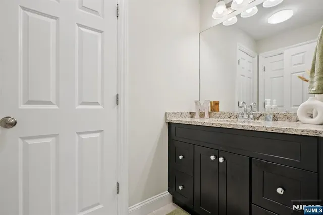 a bathroom with a sink vanity and a mirror