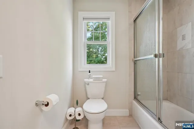 a white toilet sitting next to a bathroom sink