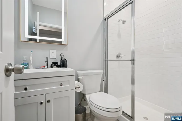 a bathroom with a sink a toilet and a mirror