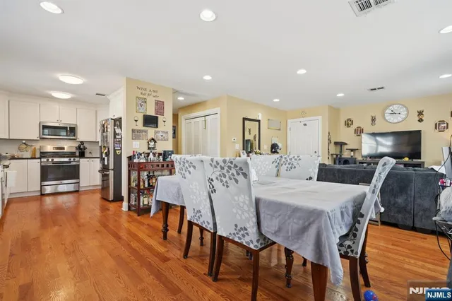a large kitchen with a table and chairs