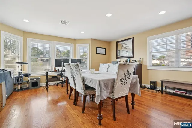 a view of a dining room with furniture window and wooden floor