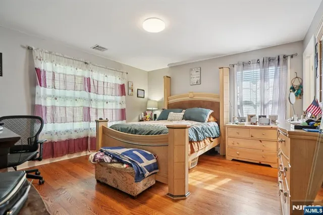 a bedroom with a bed and a large window
