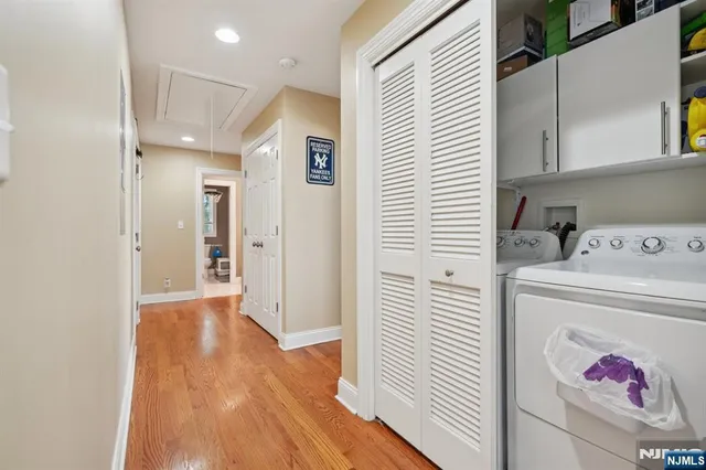 a view of a hallway with entryway and wooden floor