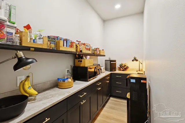 a kitchen with stainless steel appliances granite countertop a sink dishwasher and cabinets with wooden floor