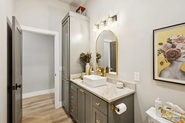 a bathroom with a granite countertop sink a mirror and a shower