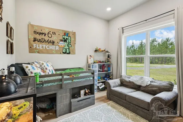 a living room with furniture a window and a flat screen tv