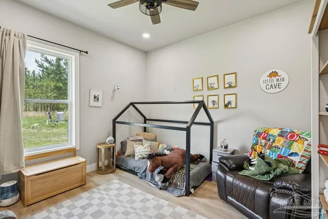 a bedroom with furniture and a window