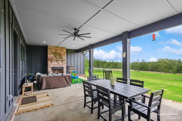 a view of a patio with a table chairs and a backyard