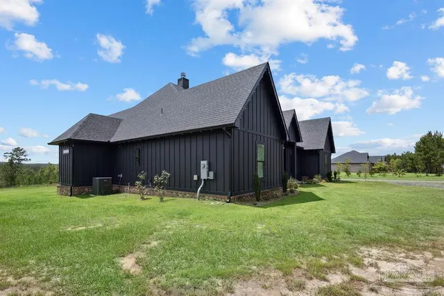 a view of a house with a big yard and sitting area