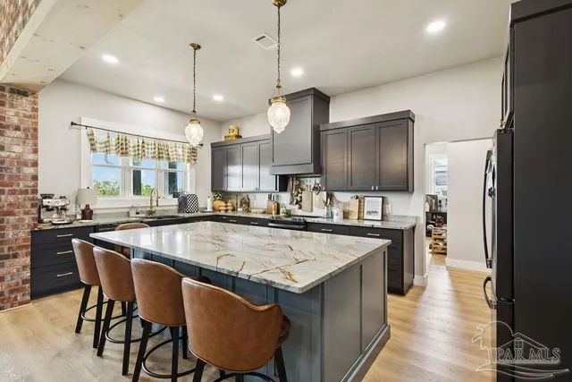 a large kitchen with a table and chairs in it