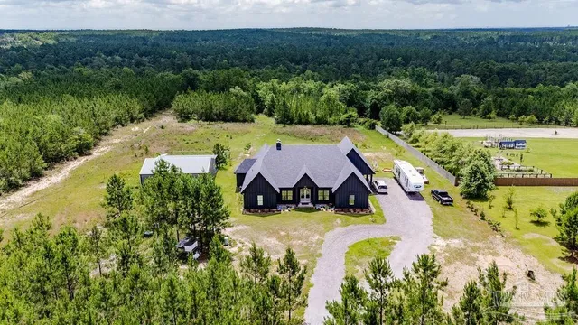 an aerial view of a house with a yard