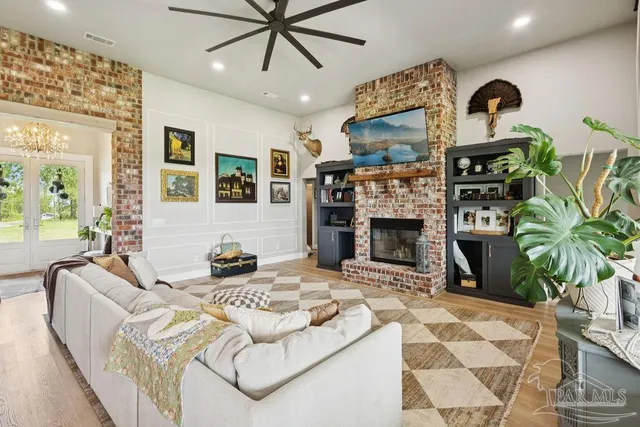a living room with furniture a flat screen tv and a fireplace
