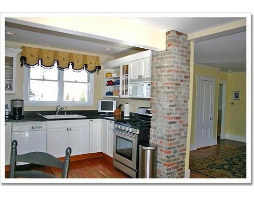 13 Short Street Cohasset, MA 02025 - Photo 10 of 20 a kitchen with stainless steel appliances kitchen island granite countertop a sink cabinets and a window