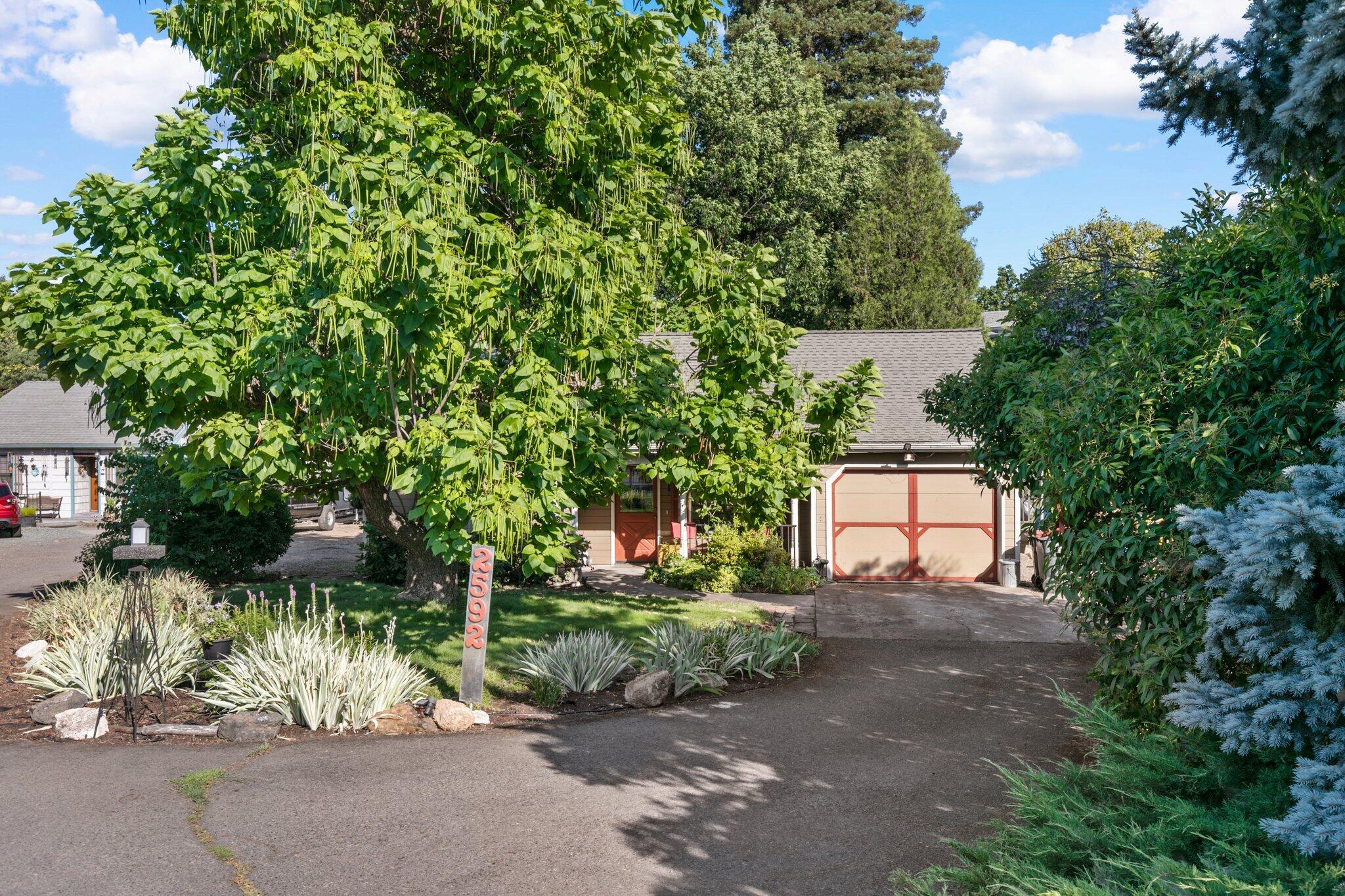 2592 Merriman Road Medford, OR 97501 - Photo 2 of 26 a backyard of a house with lots of green space