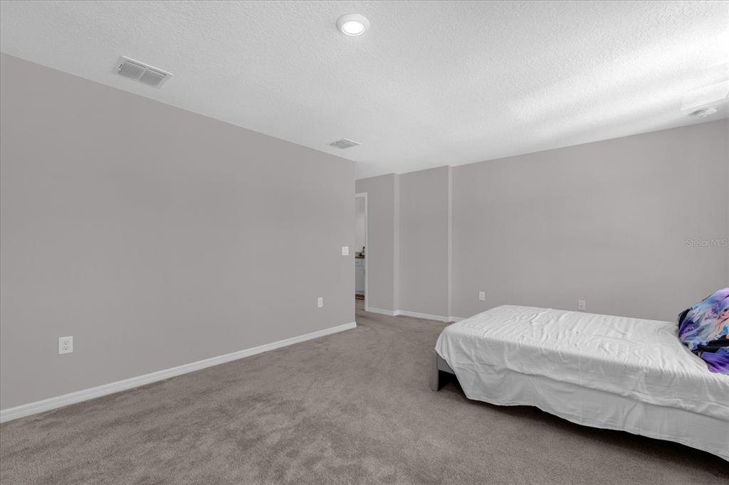 3470 Beau Road Kissimmee, FL 34746 - Photo 17 of 40 a bedroom with a bed and a window