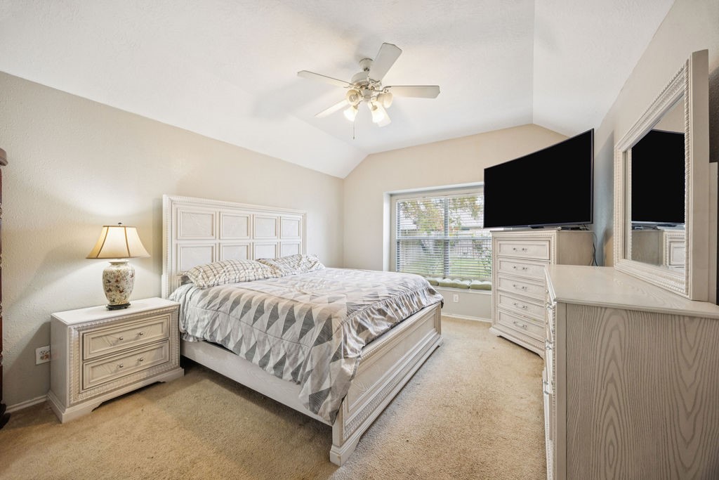 19731 Village Ridge Drive Tomball, TX 77375 - Photo 13 of 23 a spacious bedroom with a bed and a flat screen tv