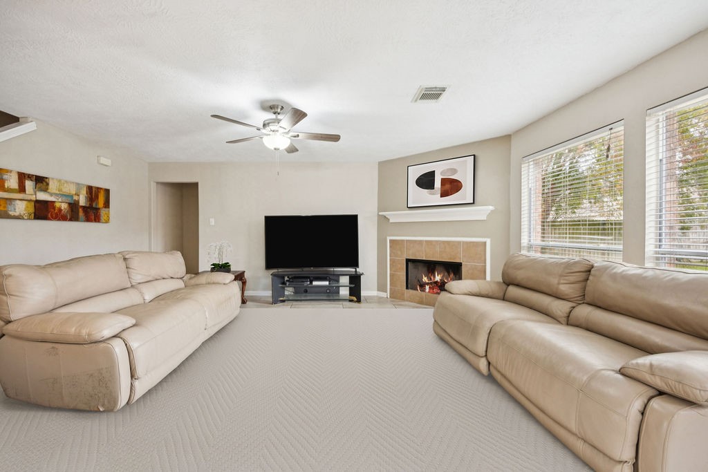 19731 Village Ridge Drive Tomball, TX 77375 - Photo 7 of 23 a living room with furniture a fireplace and a flat screen tv