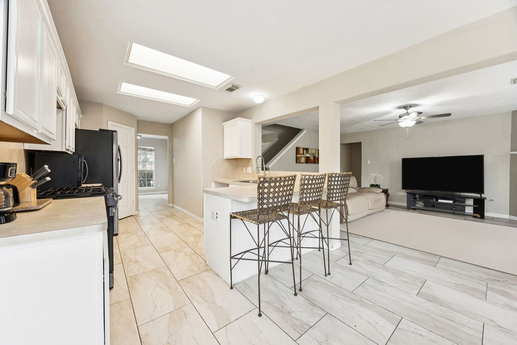 19731 Village Ridge Drive Tomball, TX 77375 - Photo 8 of 23 a view of a livingroom with furniture and a flat screen tv