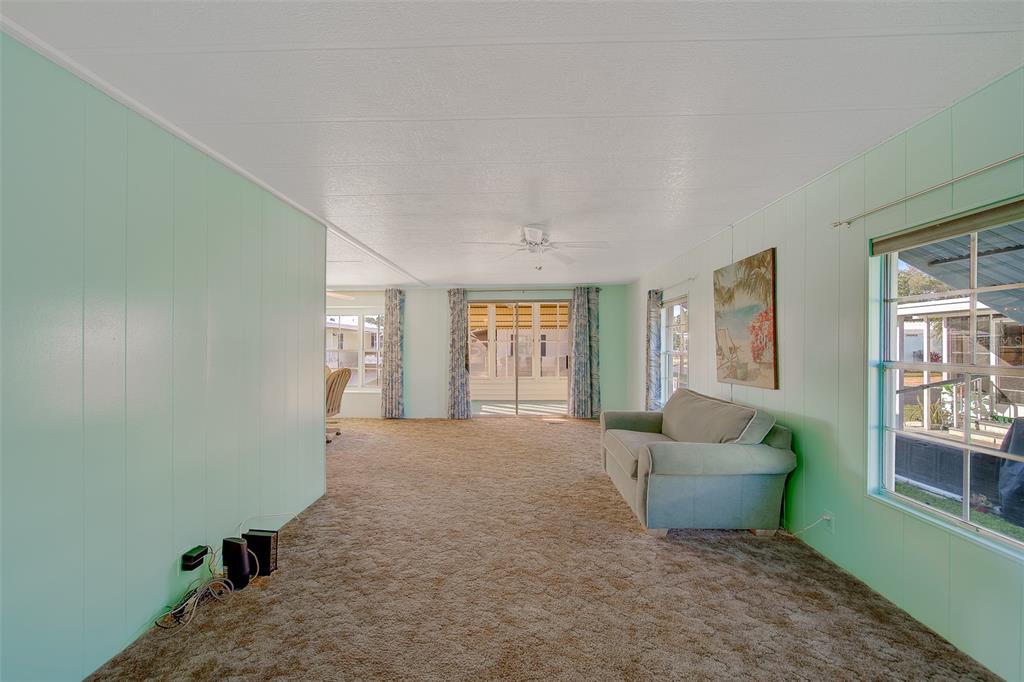 12501 Ulmerton Road, Unit 128 Largo, FL 33774 - Photo 12 of 71 a view of an empty room with wooden floor and a window