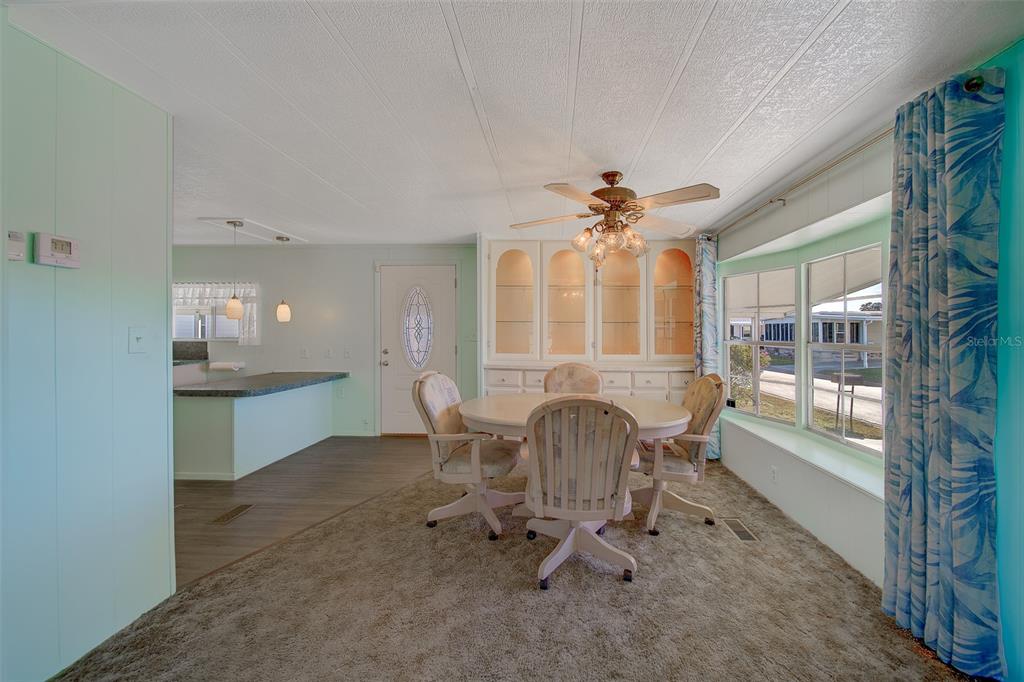 12501 Ulmerton Road, Unit 128 Largo, FL 33774 - Photo 16 of 71 a dining room with furniture and a chandelier