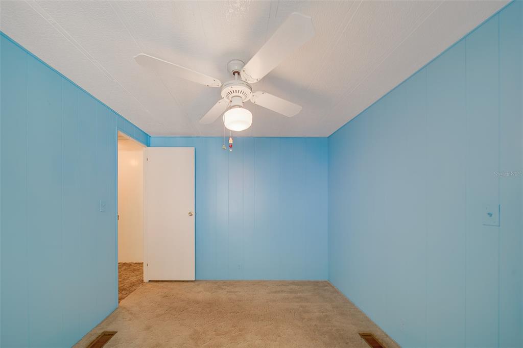 12501 Ulmerton Road, Unit 128 Largo, FL 33774 - Photo 22 of 71 an empty room with windows and fan