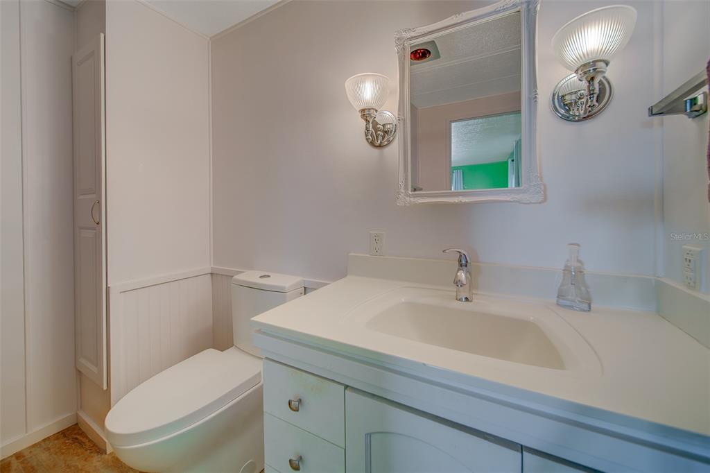 12501 Ulmerton Road, Unit 128 Largo, FL 33774 - Photo 29 of 71 a bathroom with a toilet sink and mirror