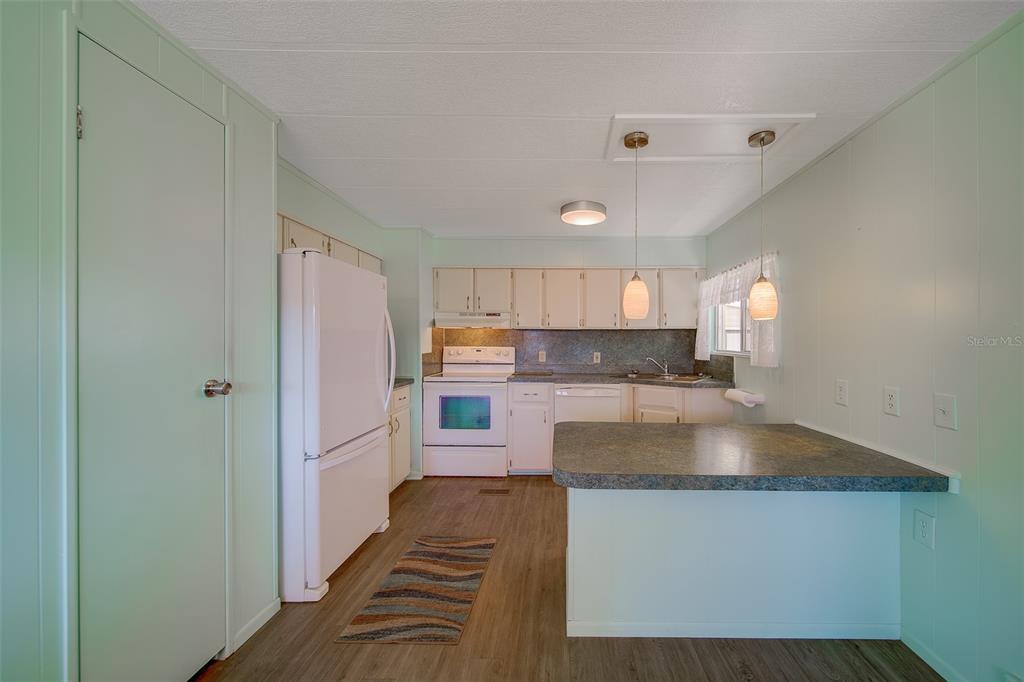 12501 Ulmerton Road, Unit 128 Largo, FL 33774 - Photo 3 of 71 a kitchen with a refrigerator and a sink