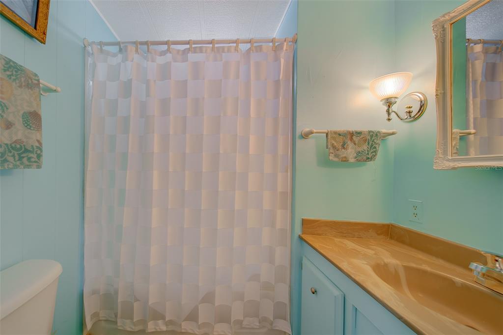 12501 Ulmerton Road, Unit 128 Largo, FL 33774 - Photo 32 of 71 a bathroom with a granite countertop sink and a mirror