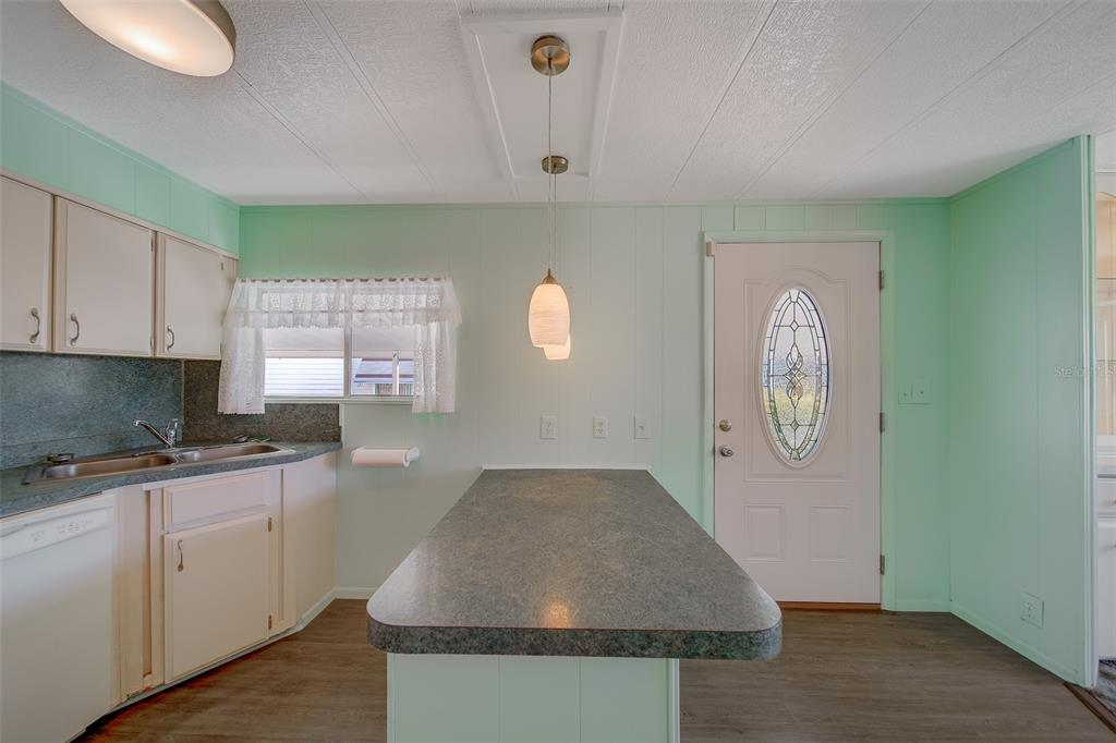 12501 Ulmerton Road, Unit 128 Largo, FL 33774 - Photo 5 of 71 a kitchen with granite countertop a sink a stove and cabinets