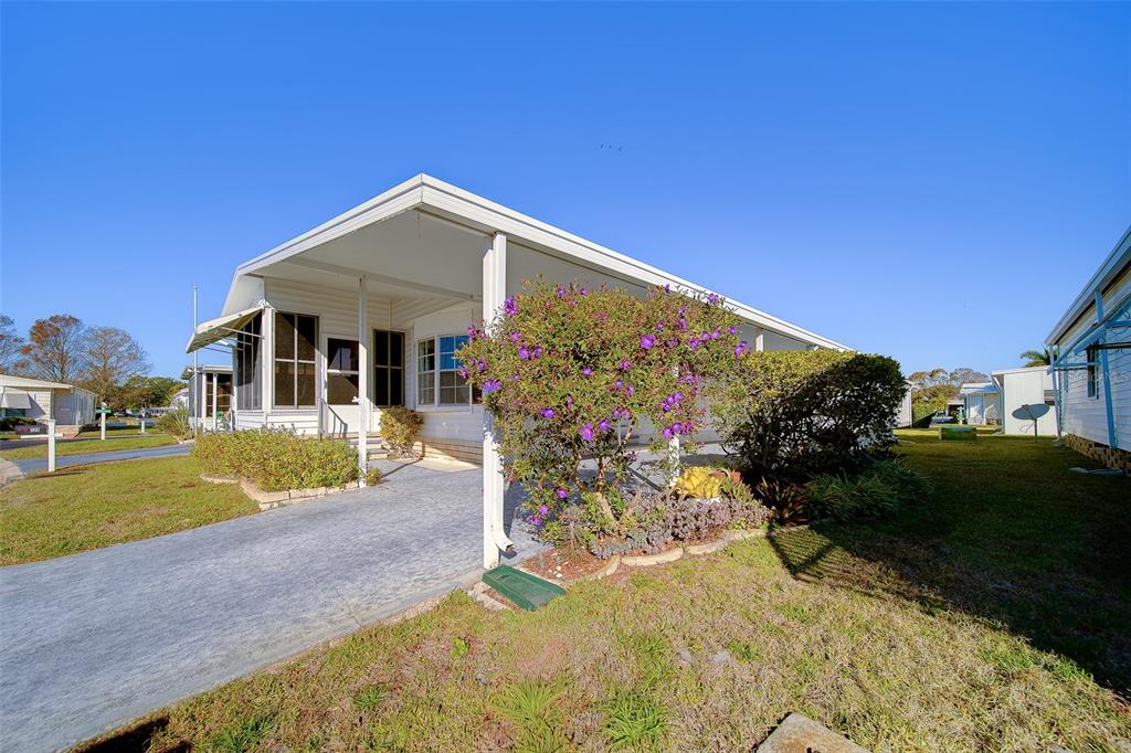12501 Ulmerton Road, Unit 128 Largo, FL 33774 - Photo 52 of 71 a front view of a house with garden