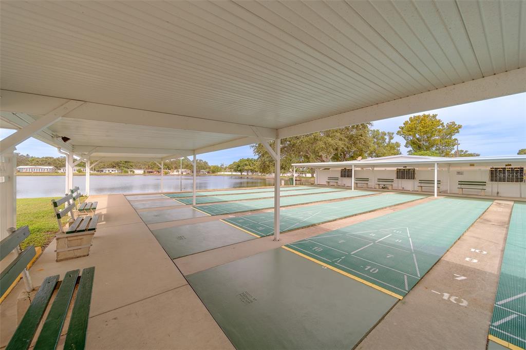 12501 Ulmerton Road, Unit 128 Largo, FL 33774 - Photo 69 of 71 a view of a patio with table and chairs with wooden floor