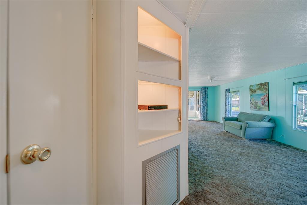 12501 Ulmerton Road, Unit 128 Largo, FL 33774 - Photo 10 of 71 a view of a hallway with bathroom and a window