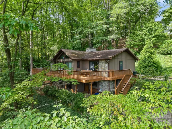 an aerial view of a house with a yard balcony and seating space