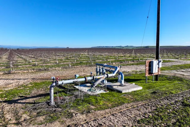 a view of a ocean with a table and chairs