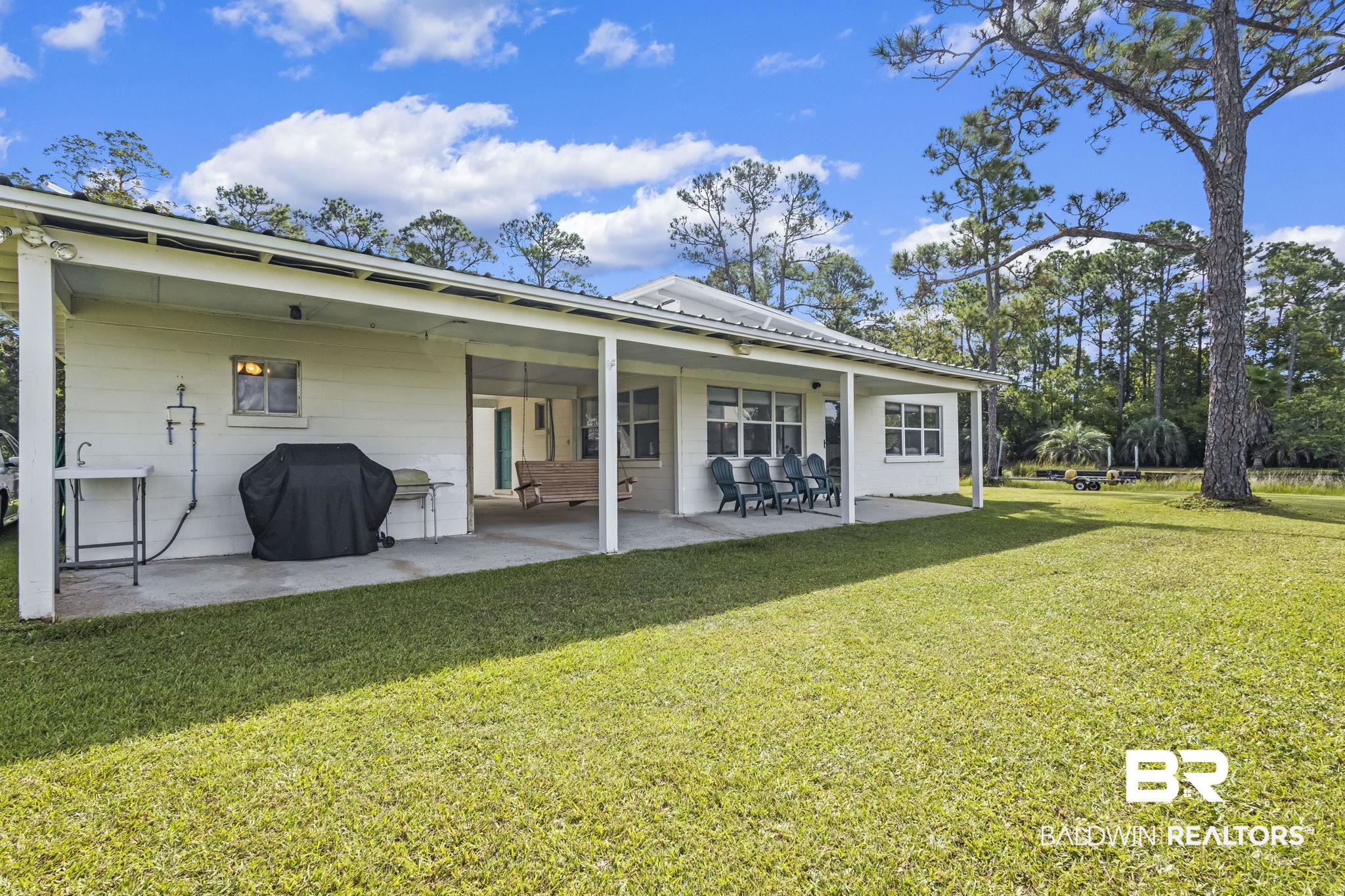 7849 Bayshore Drive Elberta, AL 36530 - Photo 42 of 47 Rear view of house with a lawn and a patio area