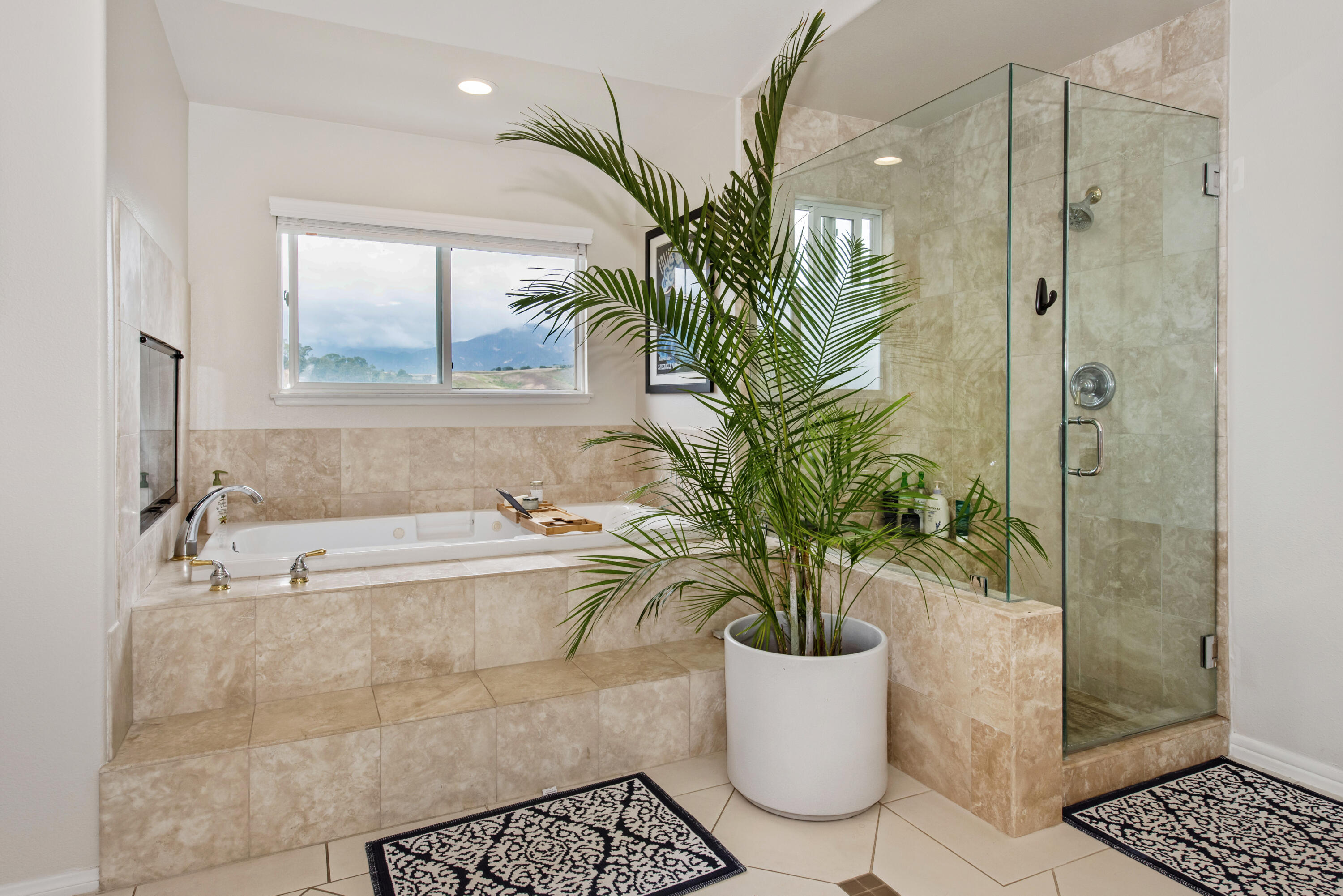 7906 Winchester Circle Goleta, CA 93117 - Photo 12 of 26 a white bath tub sitting in a bathroom next to a window