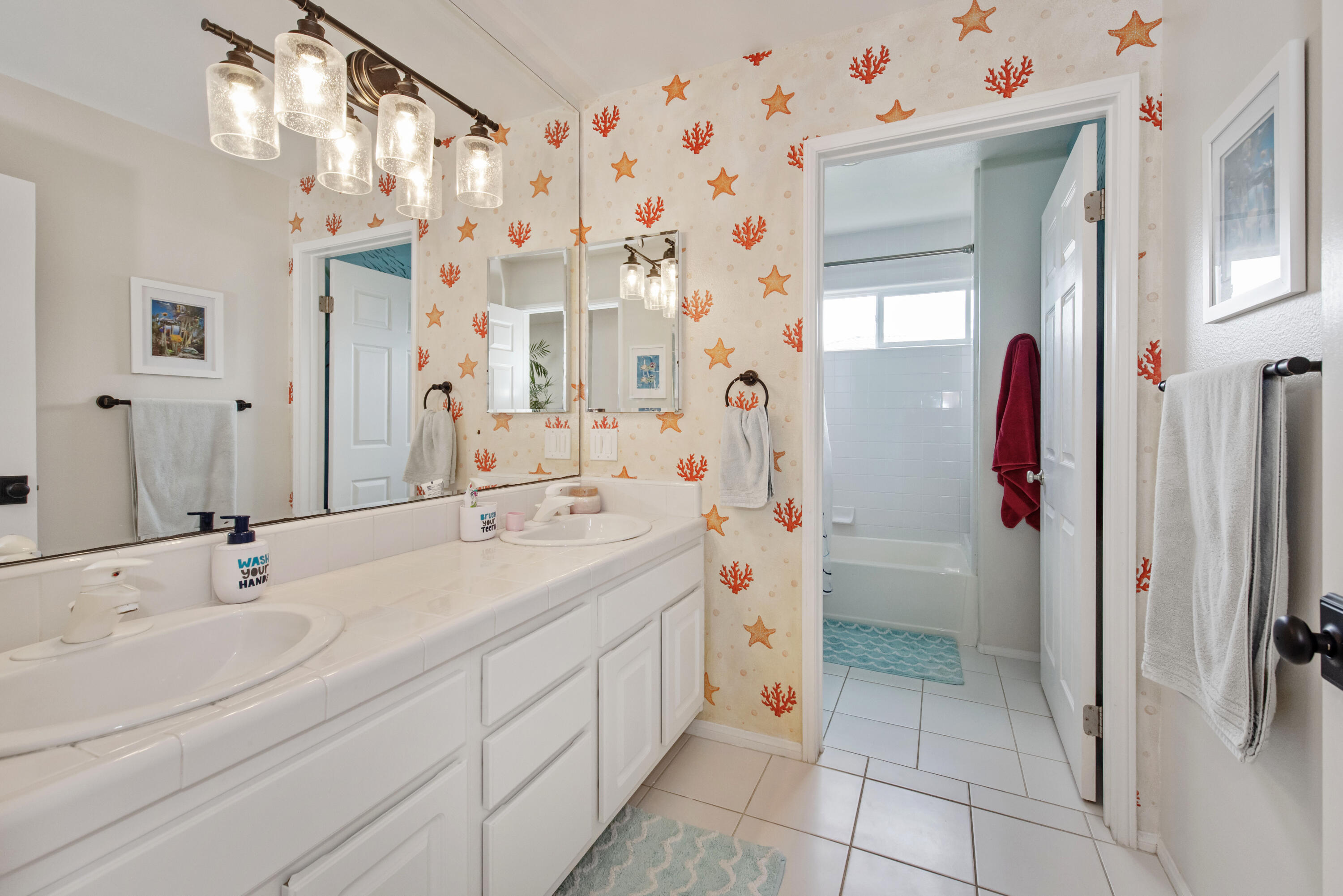 7906 Winchester Circle Goleta, CA 93117 - Photo 16 of 26 a bathroom with a sink mirror and a shower