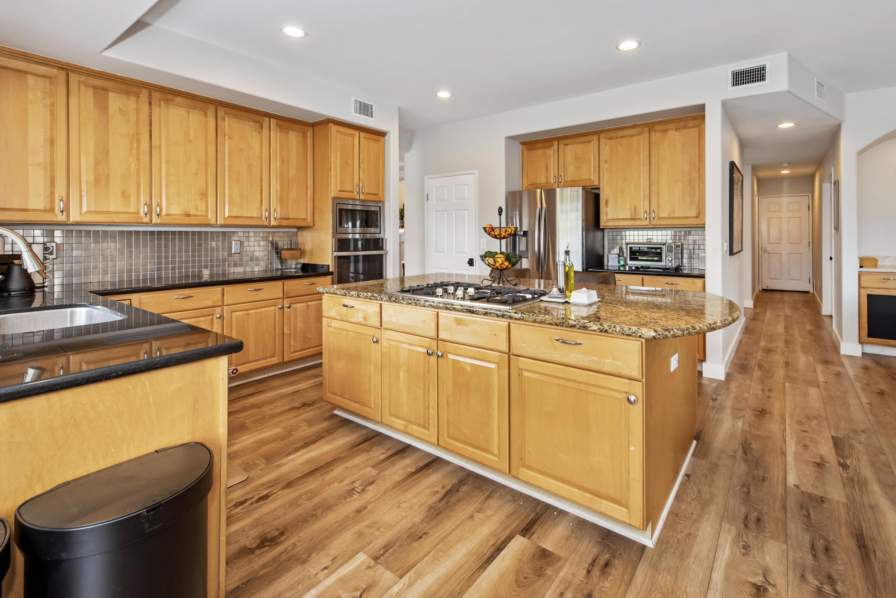 7906 Winchester Circle Goleta, CA 93117 - Photo 8 of 26 a kitchen with stainless steel appliances granite countertop a sink a stove and cabinets