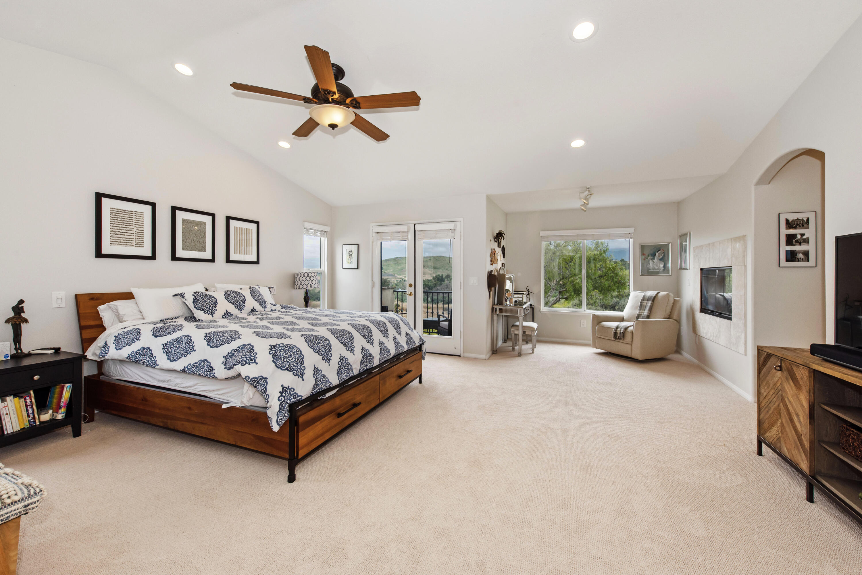 7906 Winchester Circle Goleta, CA 93117 - Photo 10 of 26 a spacious bedroom with a bed couch and a ceiling fan