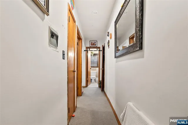 a view of a hallway with wooden floor and glass door