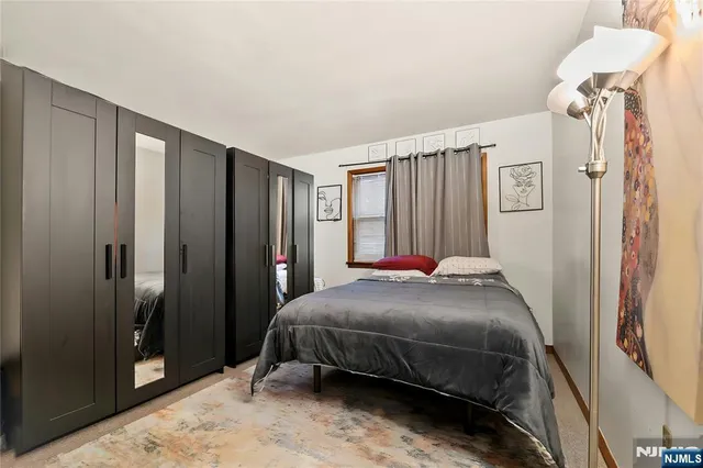 a bedroom with a bed and a mirror