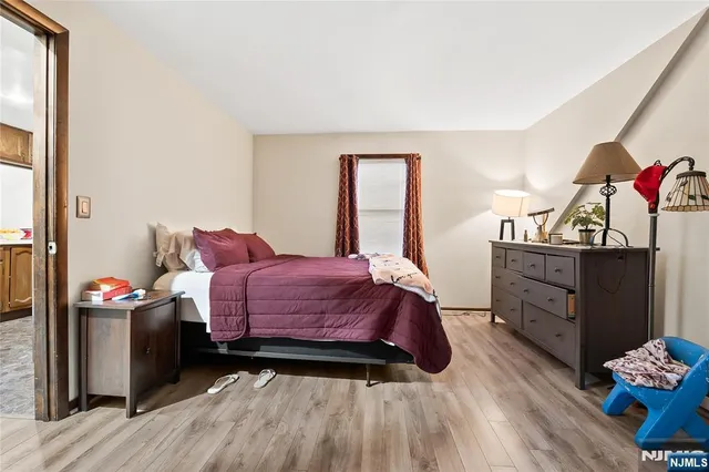 a bedroom with a bed and a dresser