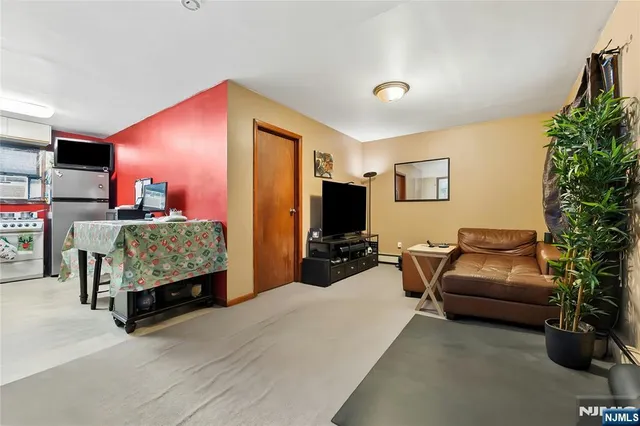a bedroom with furniture and a flat screen tv