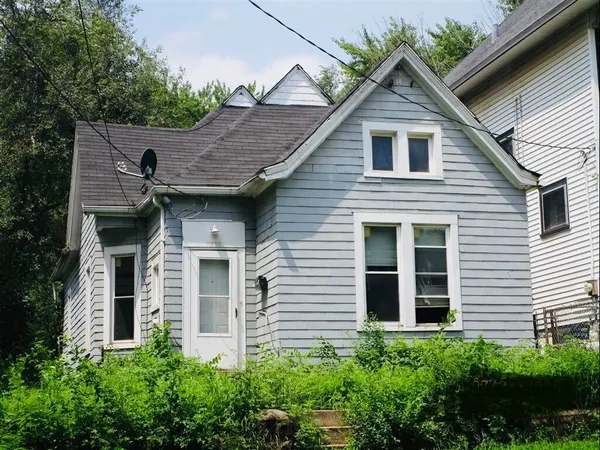 a view of a house with brick walls and potted plants