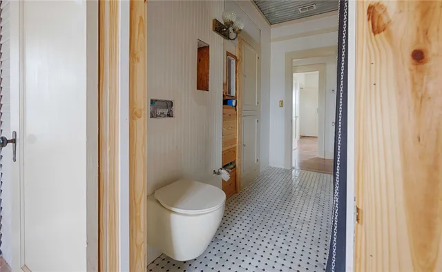 a bathroom with a toilet and a shower