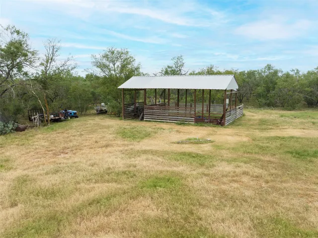 a view of a house with backyard and patio